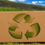 Cardboard box with a green recycling symbol on a dirt path Sustainable Packaging for E-commerce